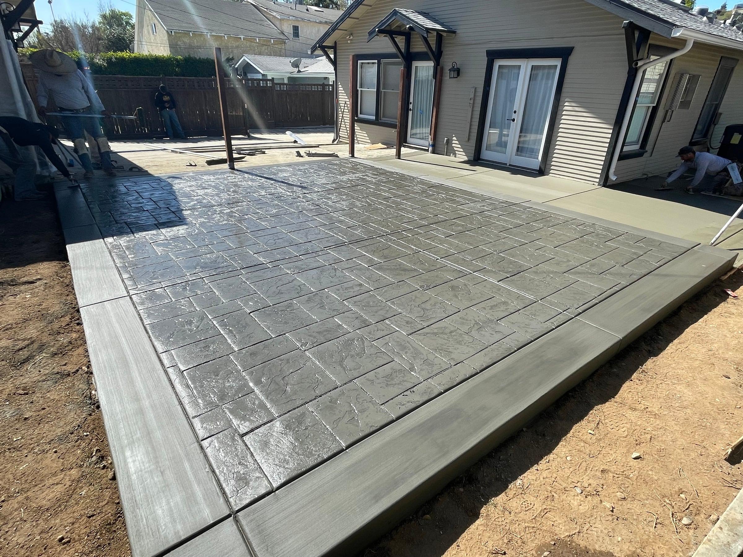 Stamped concrete patio with a wood-plank border pattern