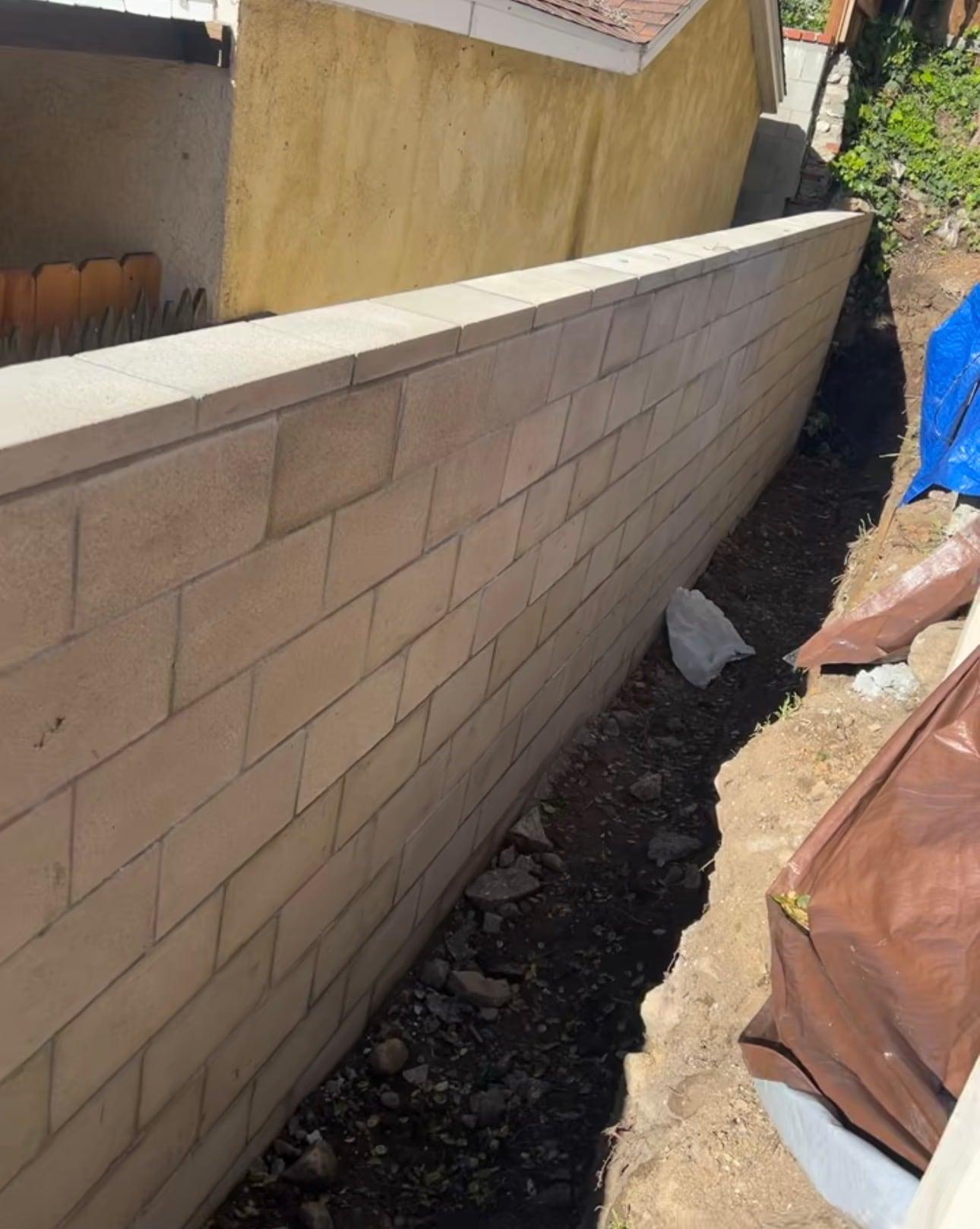 New concrete block retaining wall with a capped top