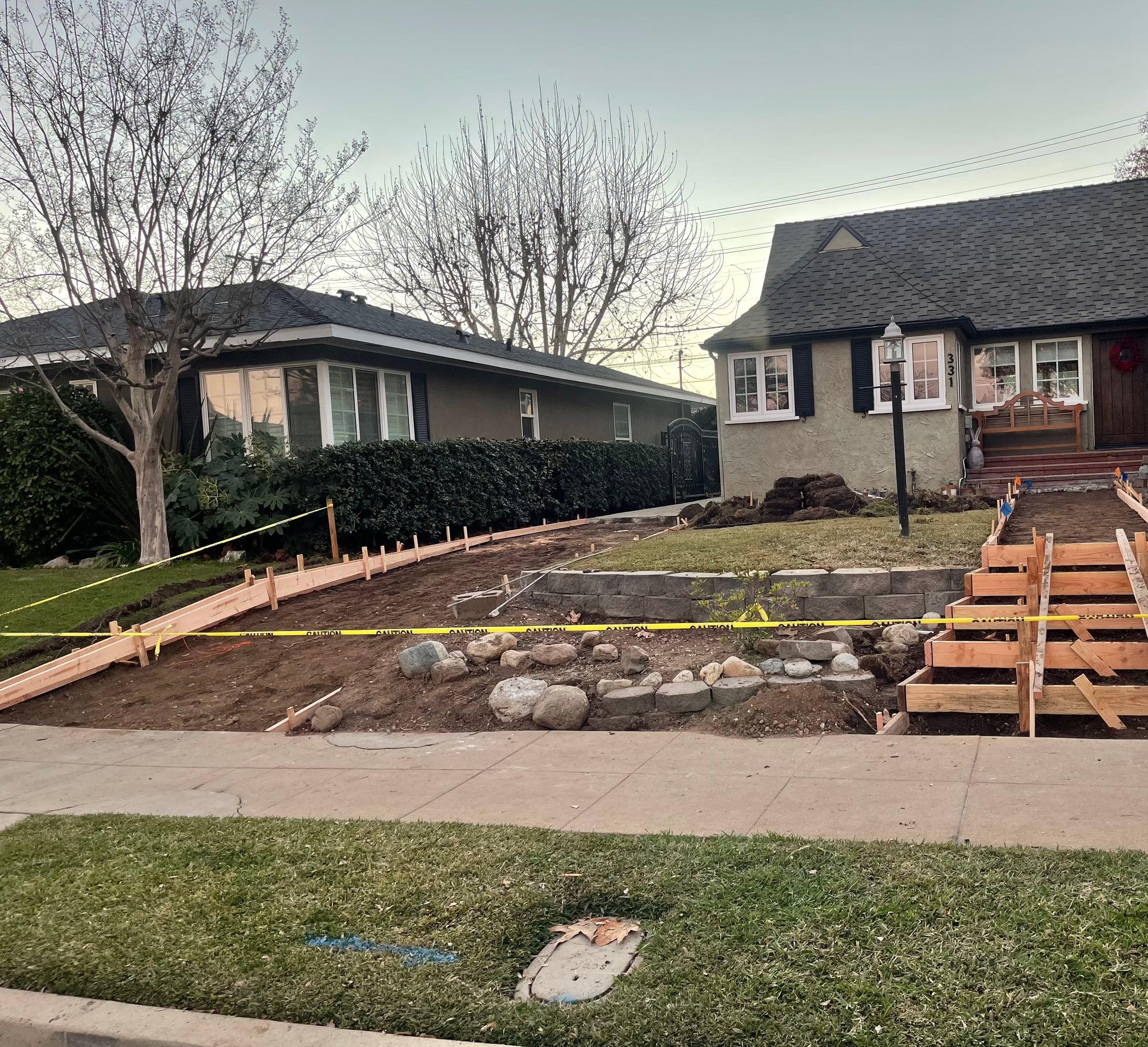 Concrete driveway and retaining wall under construction