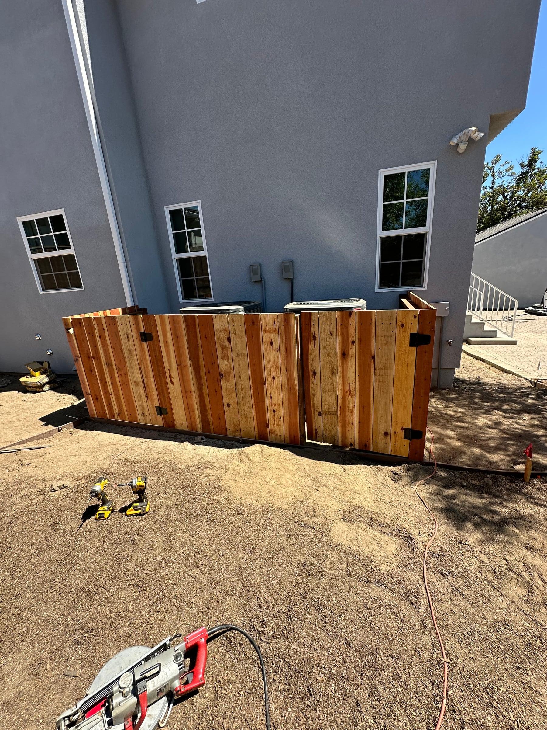 Redwood double-gate enclosure built to hide AC units