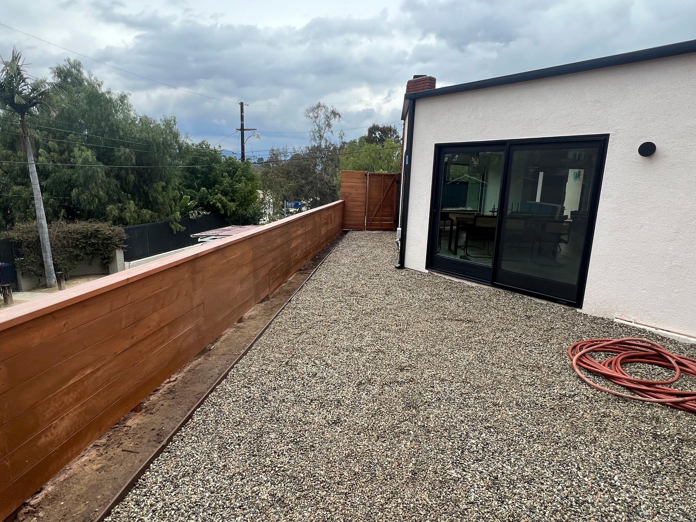 Horizontal wood fence along the edge of a rooftop deck
