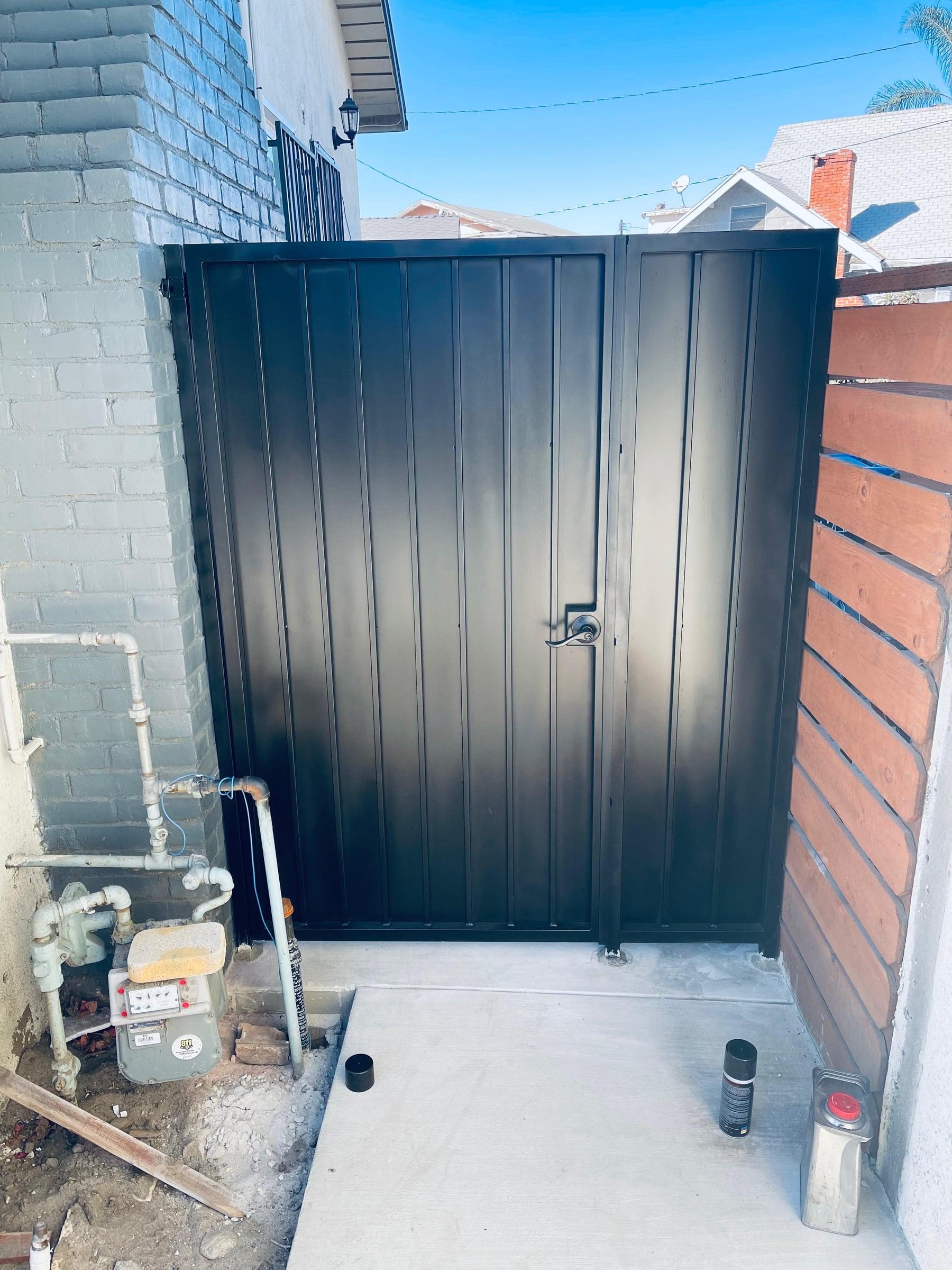 Black iron side door entryway attached to home and perimiter wall