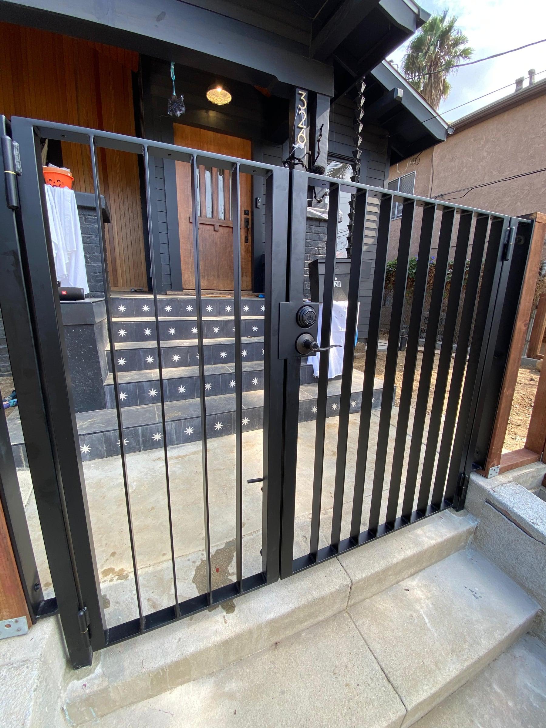 Custom iron driveway gate installed at a residential entrance