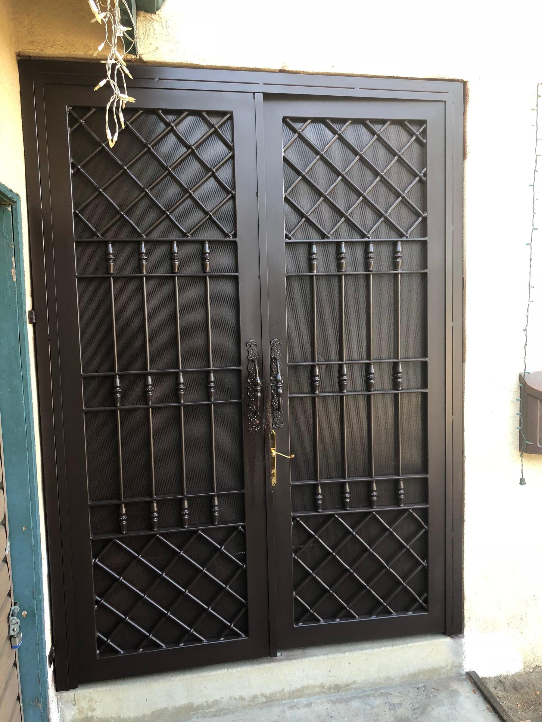 Decorative iron gate panel with scrollwork detailing