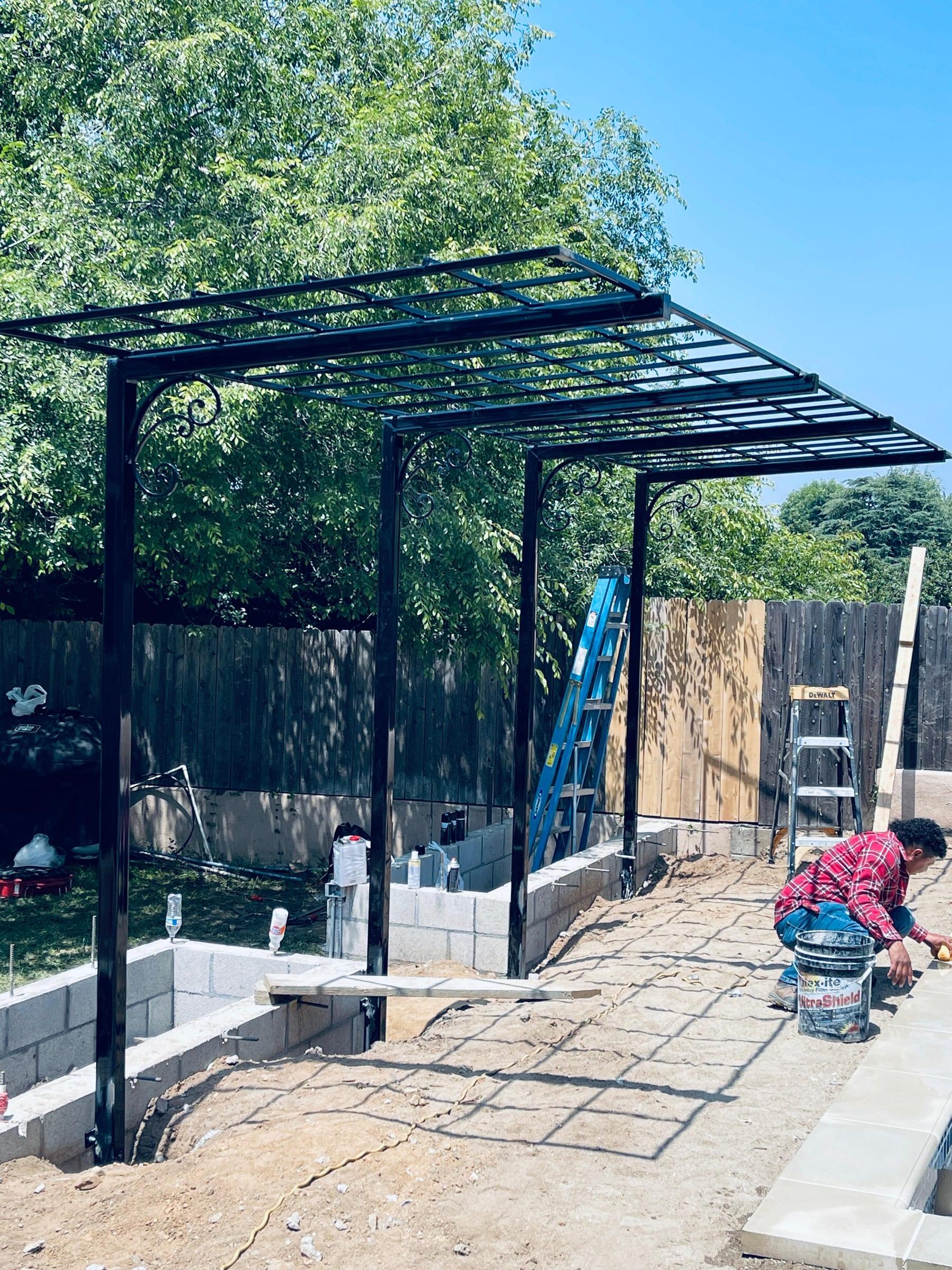 Black iron fence enclosing a residential side yard