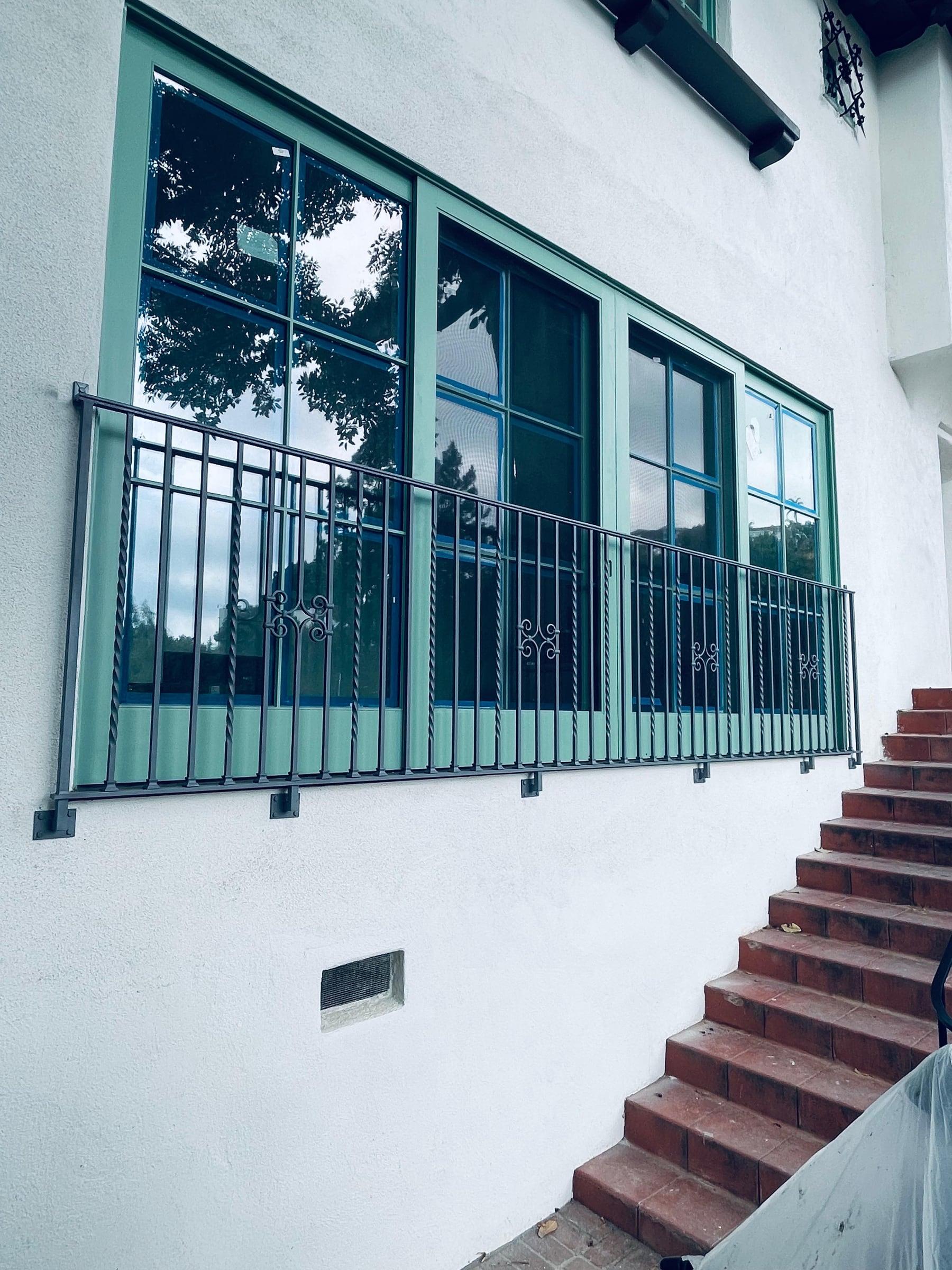 Decorative iron fence panel with custom scrollwork pattern
