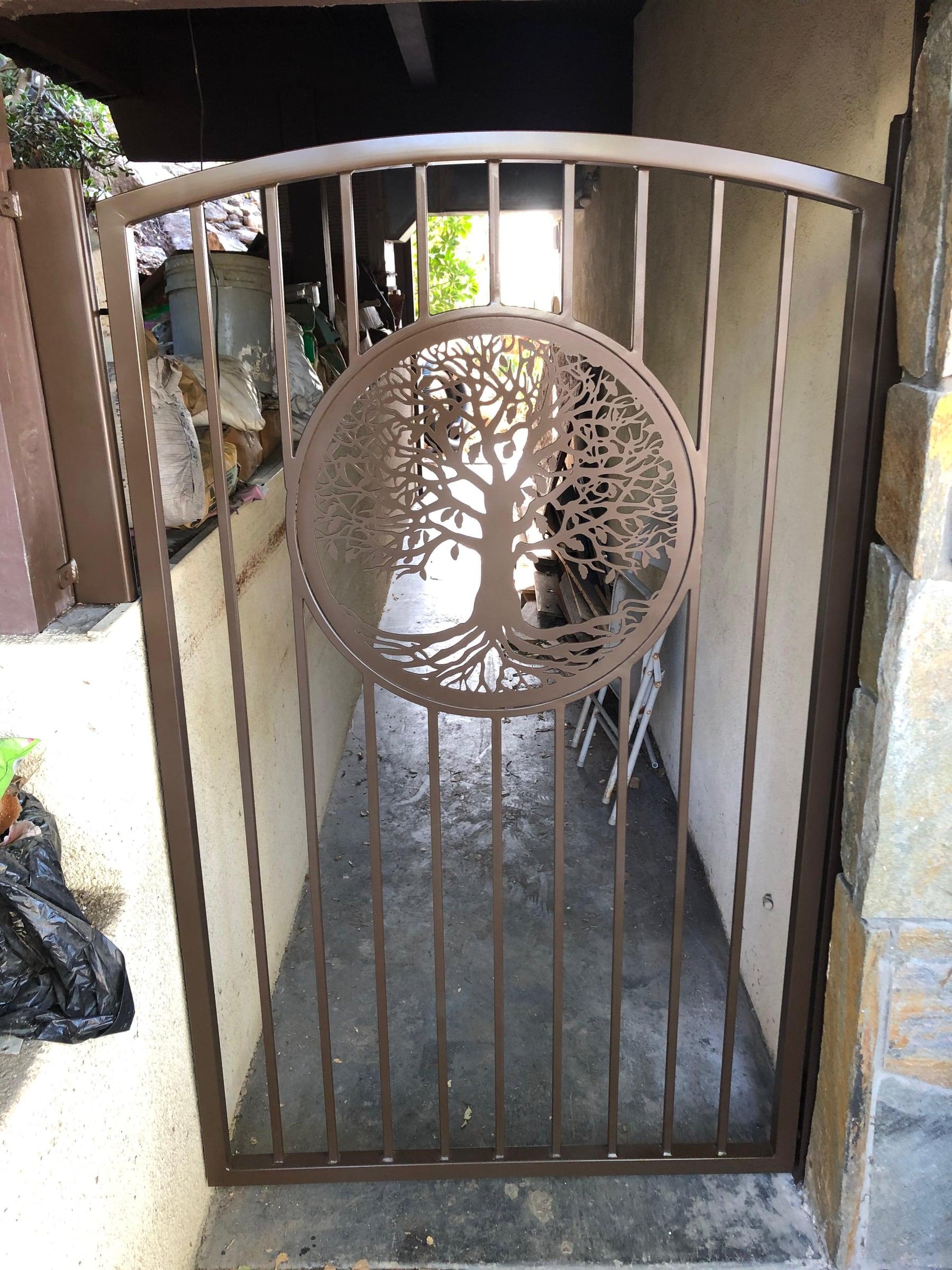 Custom metal side gate with an arched top and decorative circular cutout panel
