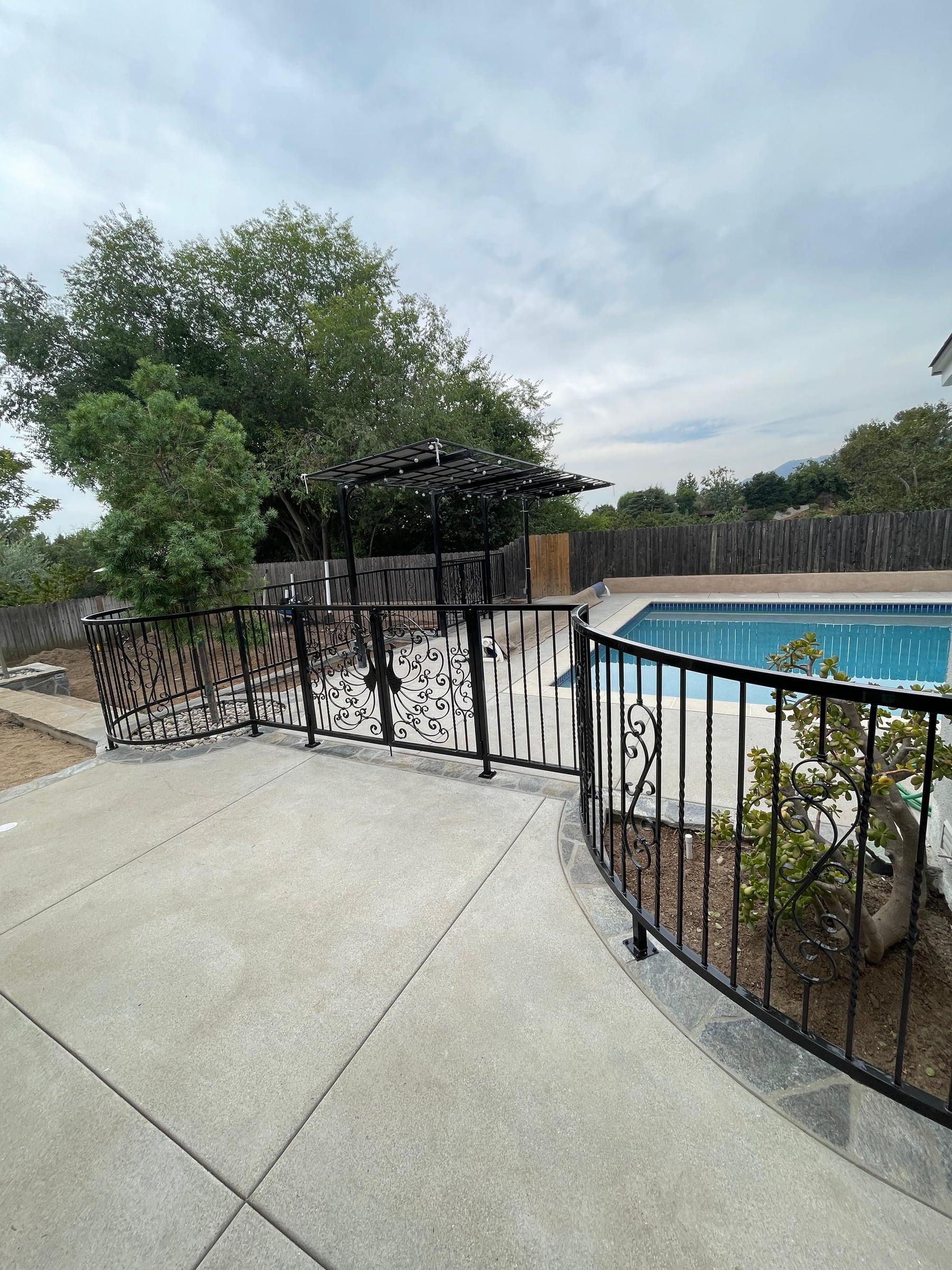 Custom iron railing installed along an exterior walkway