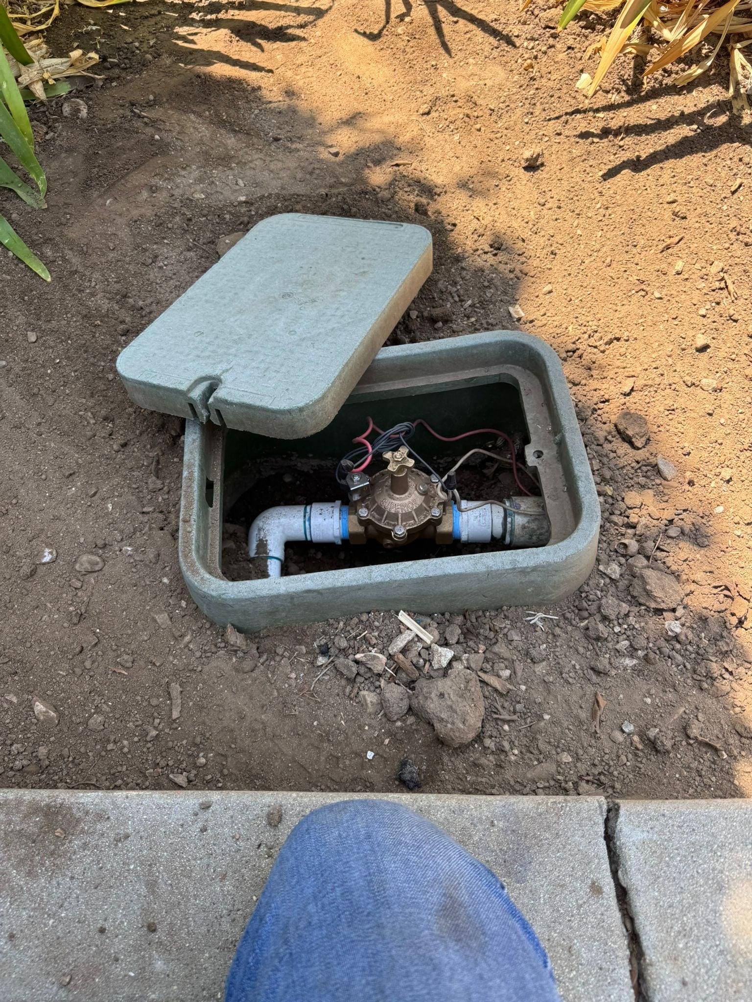 Irrigation valve box with a new brass gate valve installed