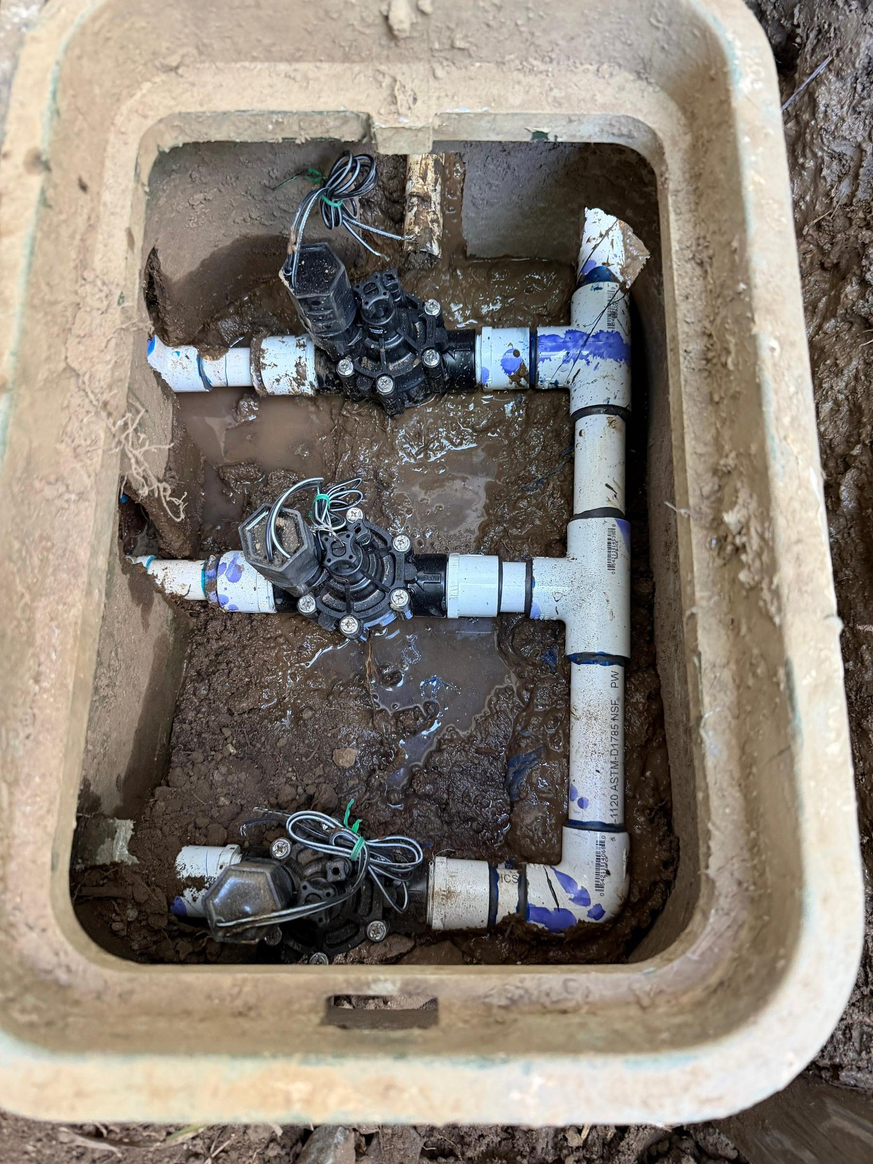 Valve box with new solenoid irrigation valves installed