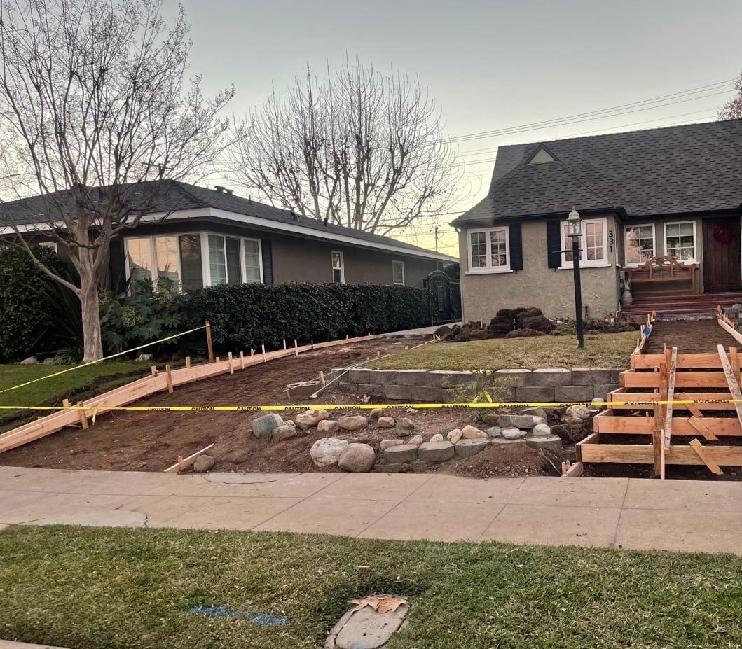 Retaining wall and steps under construction with wood forms
