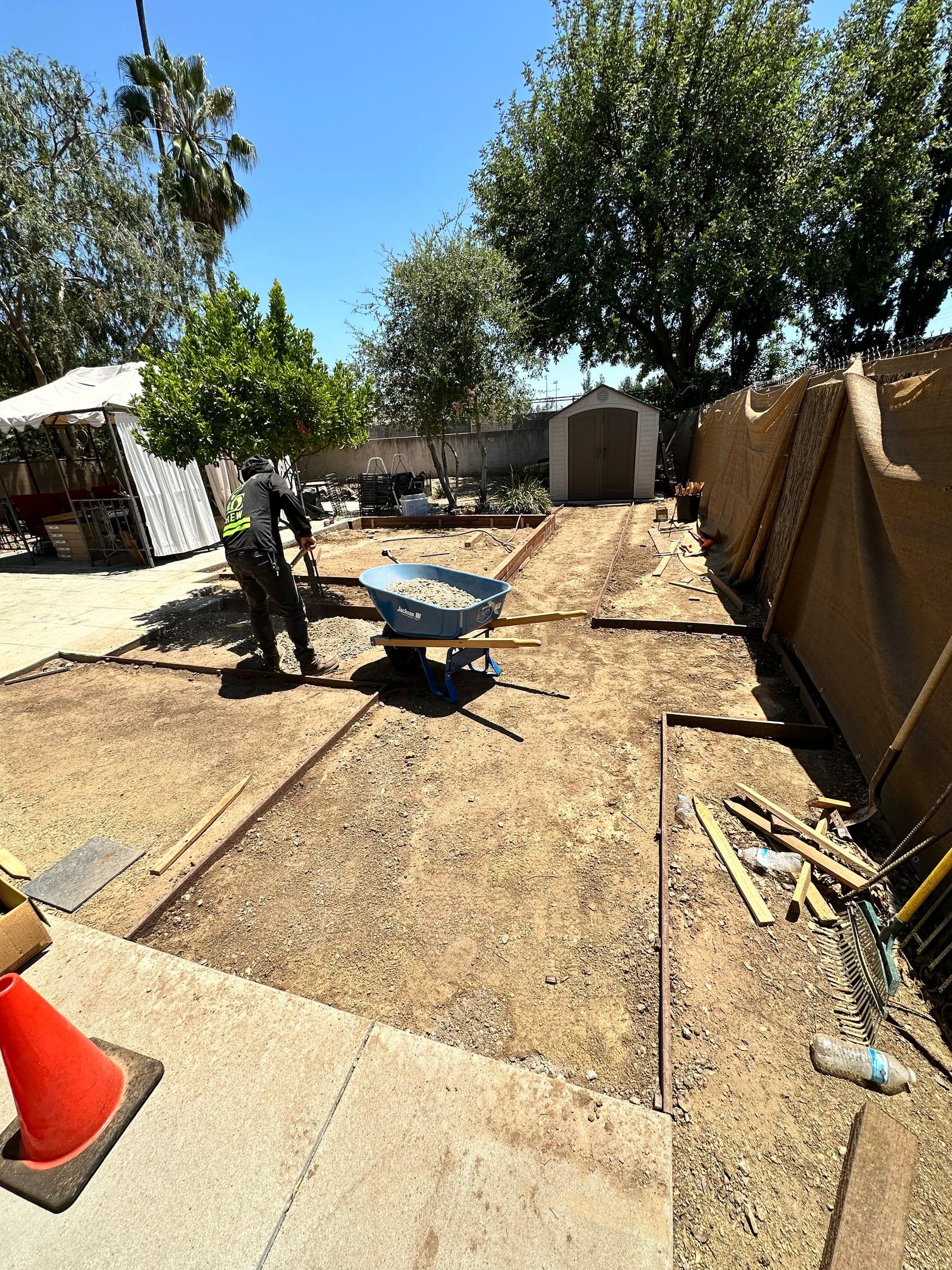 Completed concrete and masonry project combining a patio, wall, and walkway