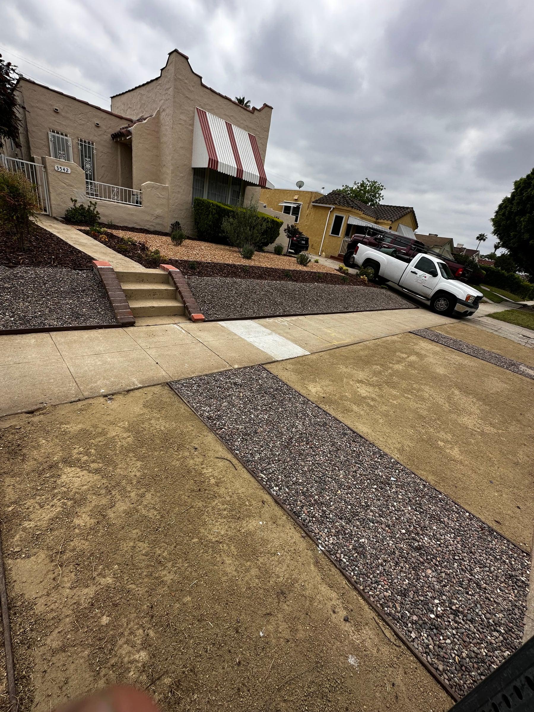 Front yard with drought-tolerant gravel bed and brick-capped steps