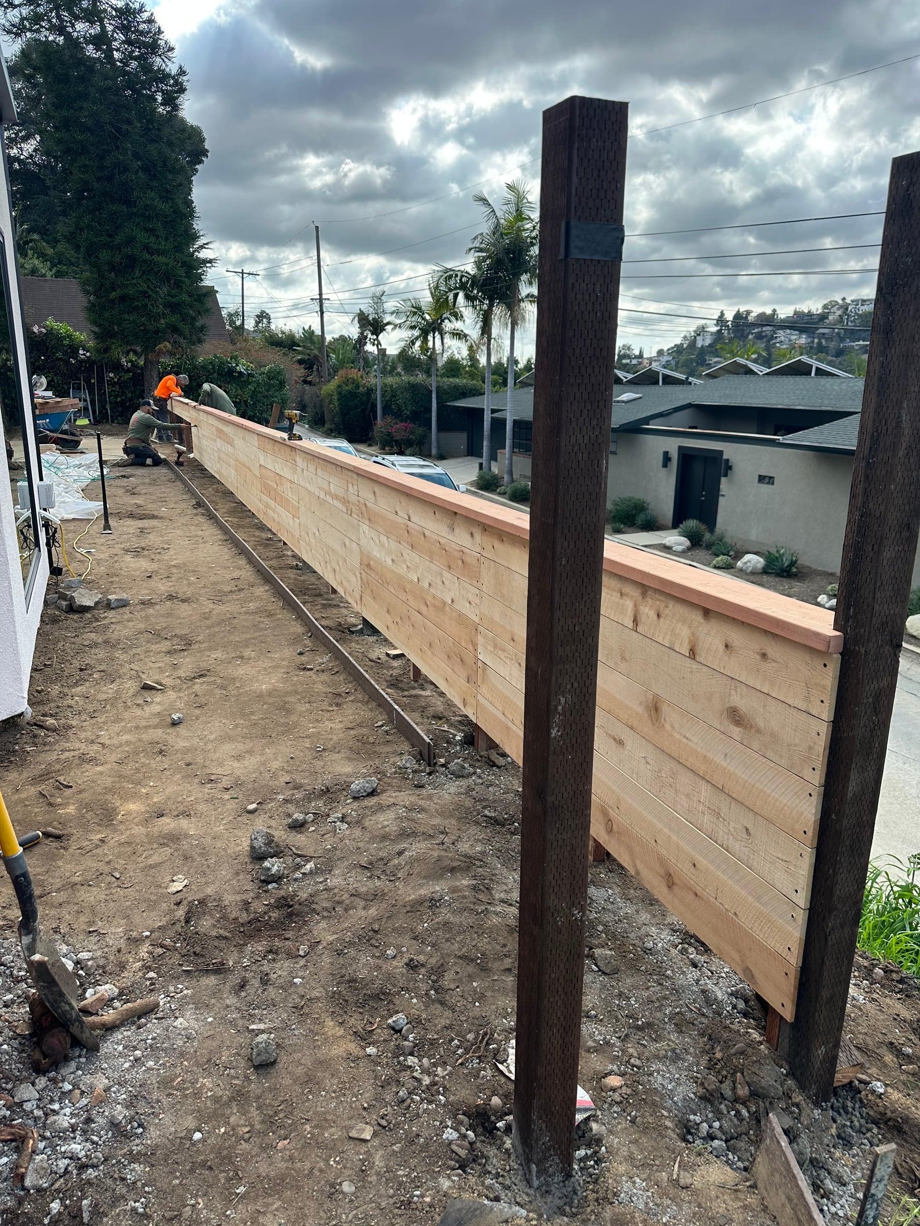 Horizontal wood fence along the edge of a rooftop deck