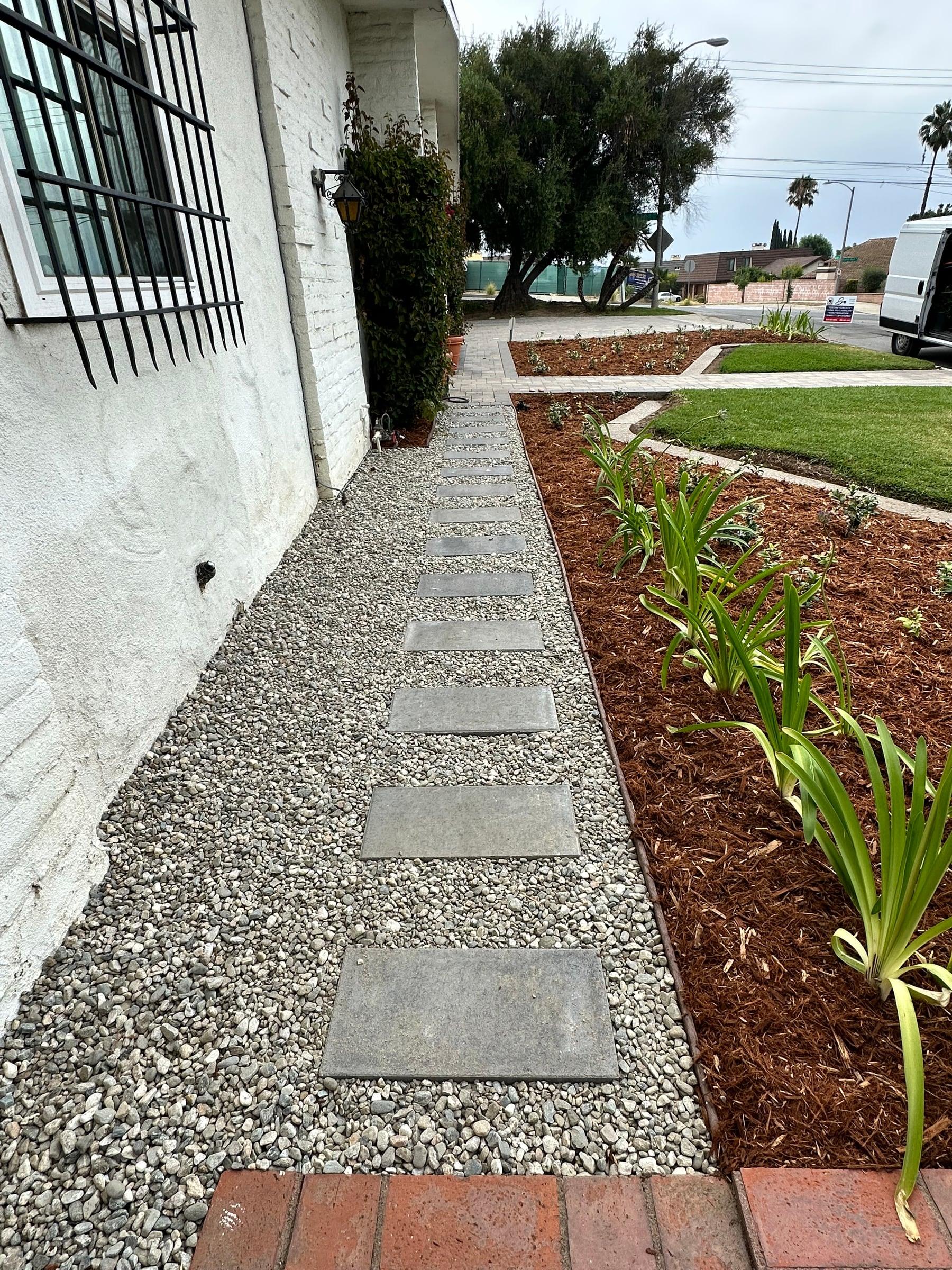 Gravel walkway beside a drought-tolerant planting bed