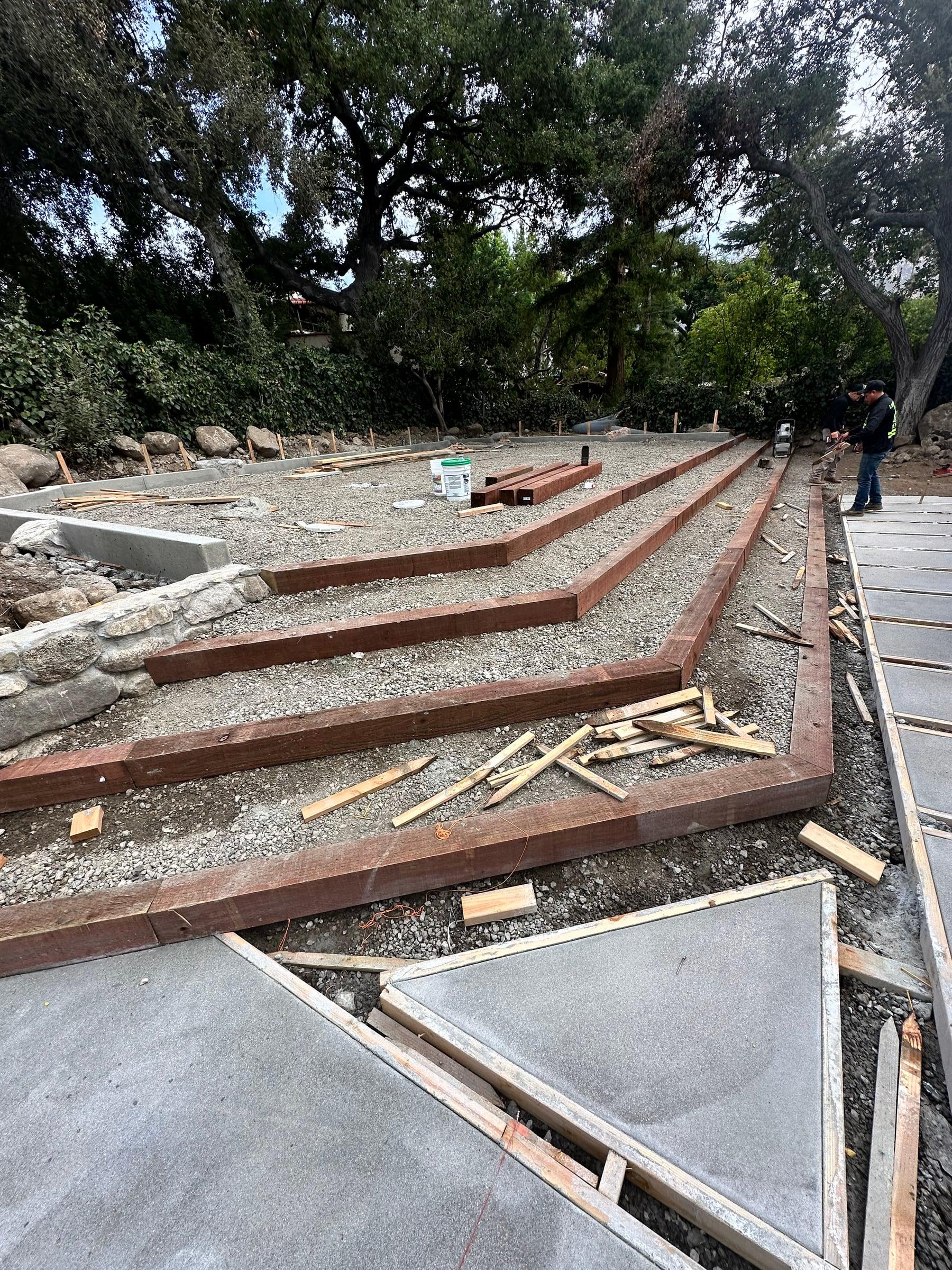 Redwood timber garden bed borders being installed
