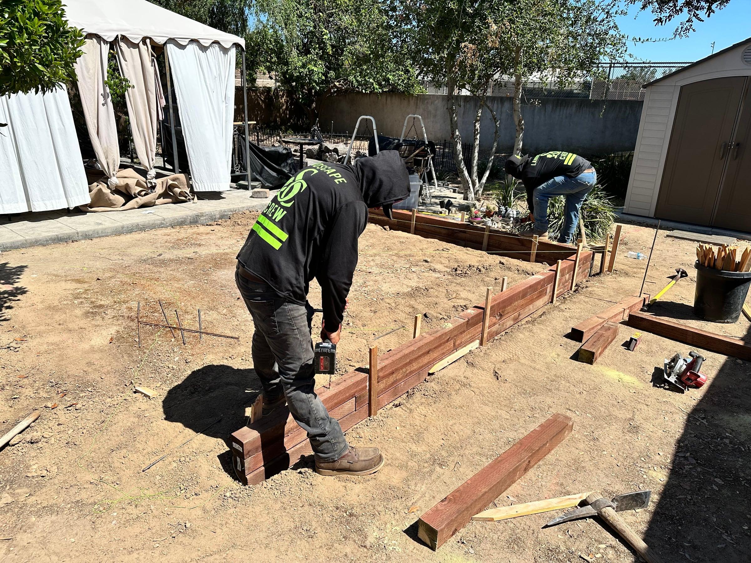 Completed concrete and masonry project combining a patio, wall, and walkway