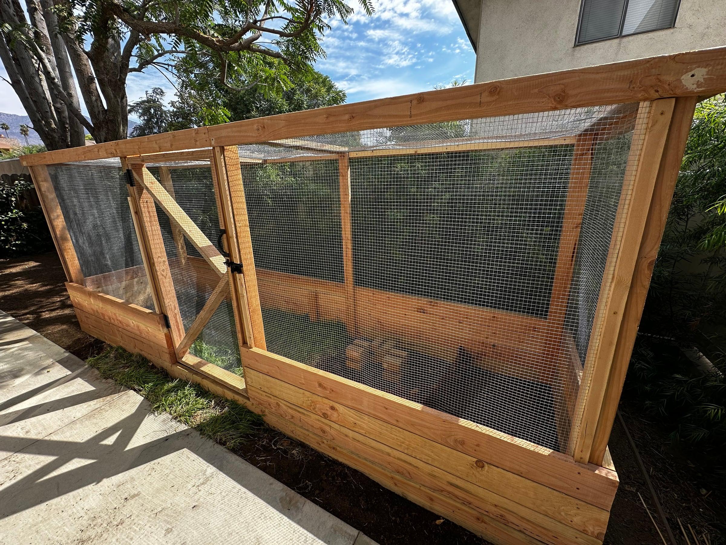 Redwood screened enclosure built along a side yard