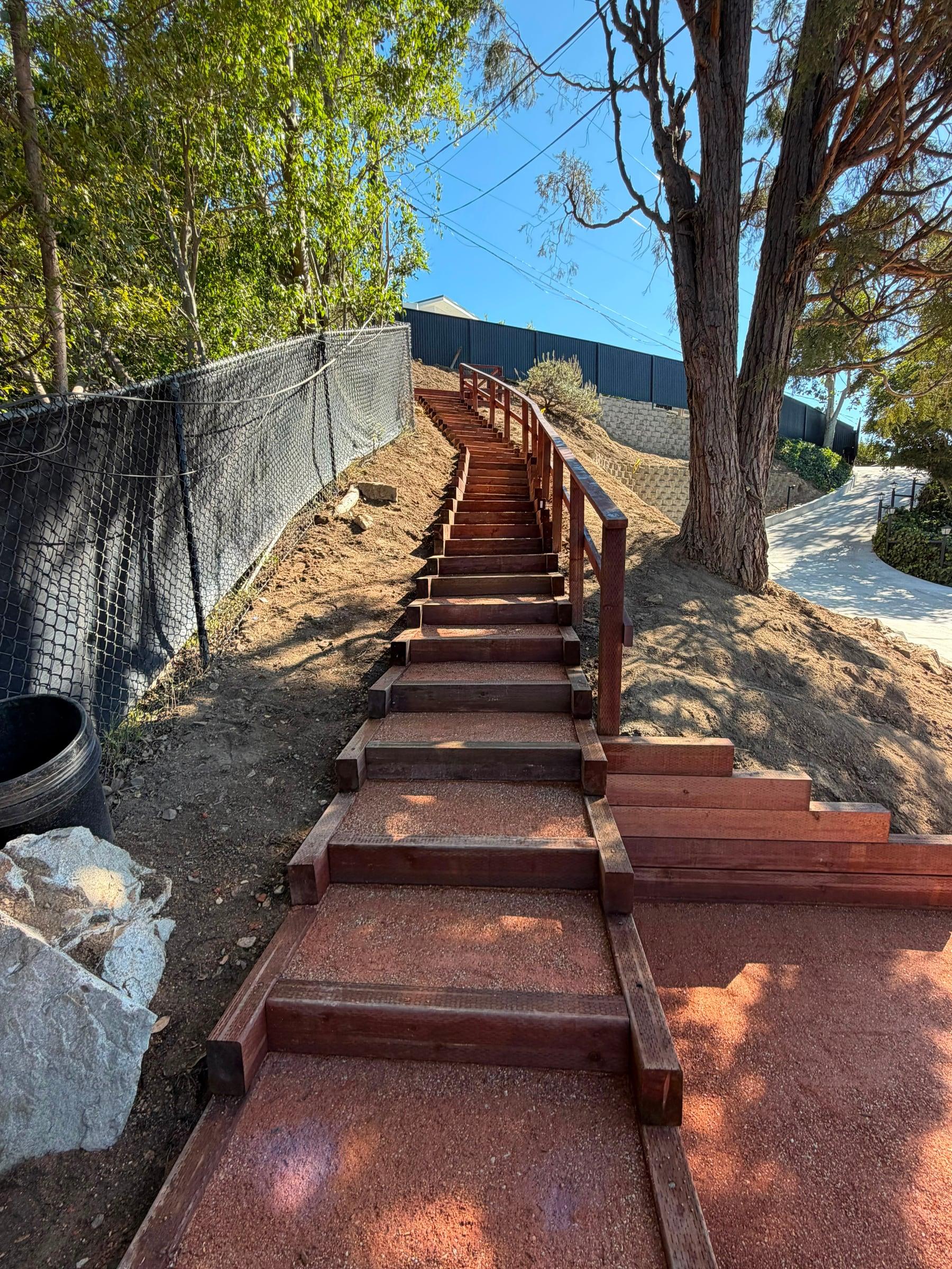 Completed hillside stairs with wood handrails