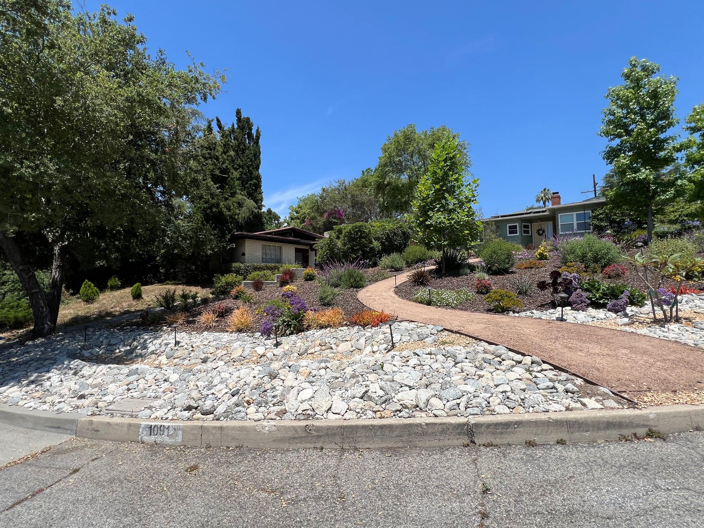 Drought-tolerant garden with river rock and flowering perennials