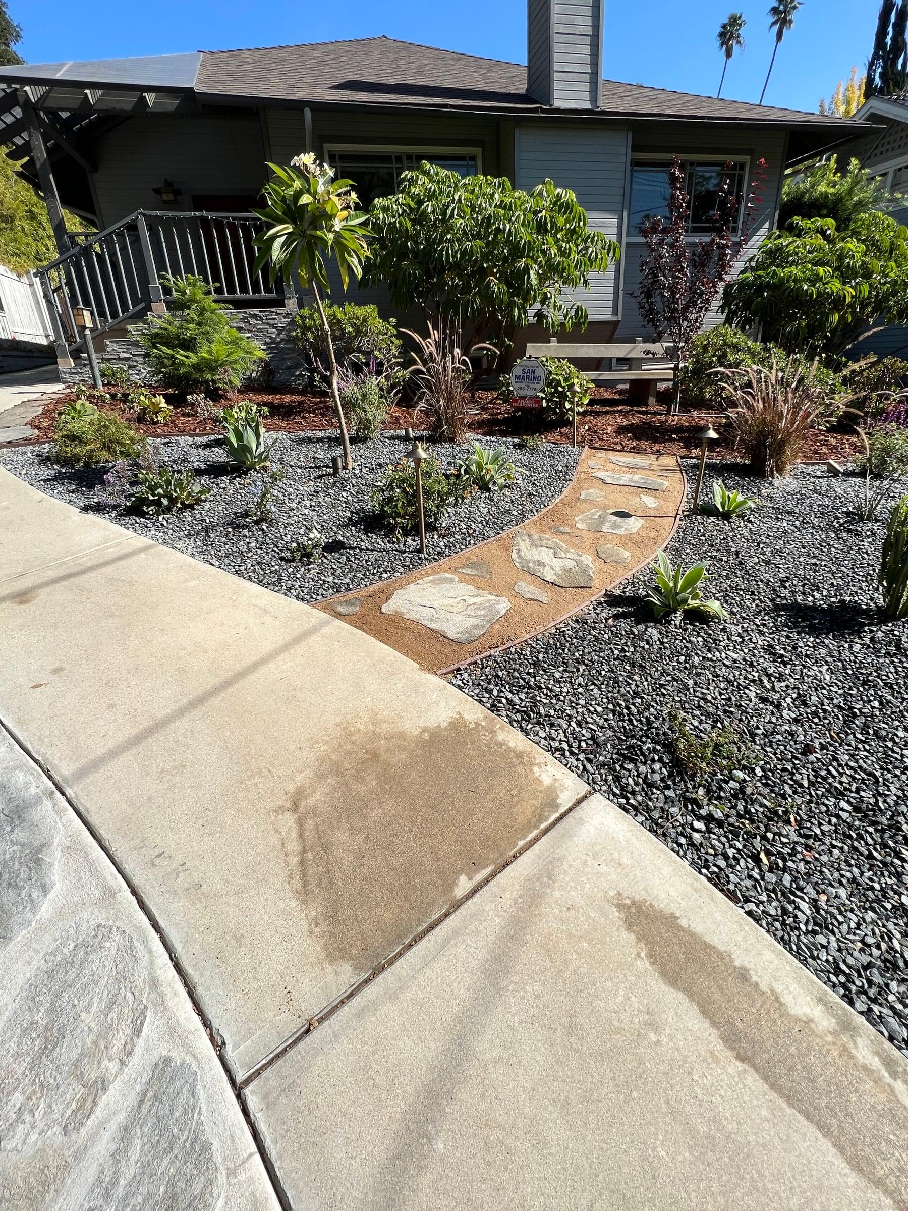 Front yard drought-tolerant garden with gravel and stepping stones